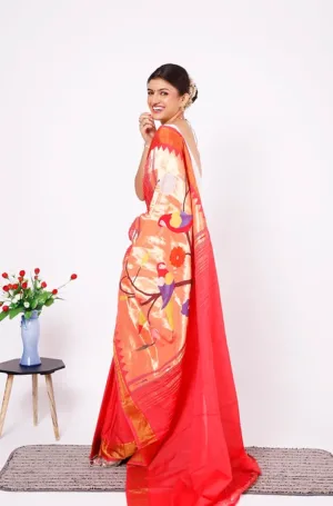 Orange and red handloom Paithani saree with rich zari border and floral pallu design, worn by woman in traditional style