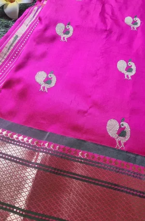 Magenta handloom tissue silk Paithani saree with silver peacock motifs and traditional zari border