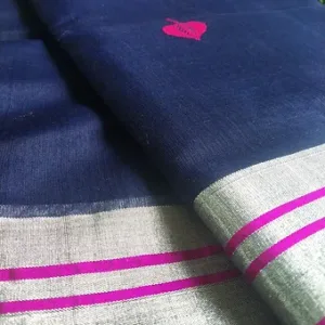 lose view of a navy blue Chanderi handloom cotton silk saree featuring a silver border enhanced with bright pink zari stripes and a small woven motif on the body, displayed on a soft fabric surface.