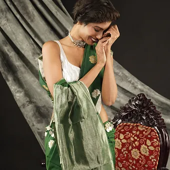 Handloom-Cotton-Silk-Chanderi-6 Woman wearing a green handloom cotton silk Chanderi saree with golden butti motifs and silver-toned pallu, posing gracefully in a studio setting; elegant festive saree look.