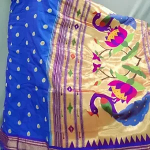 Close view of a blue cotton silk Himroo saree featuring golden zari border with colorful peacock and floral motifs, along with dotted golden butta pattern on the body.