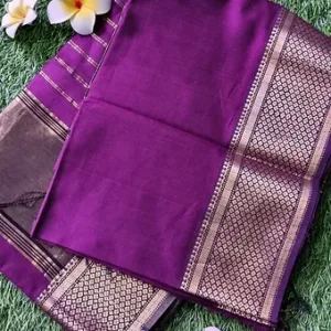Purple handloom cotton silk Maheshwari saree with silver zari border, displayed on green grass with flowers; elegant traditional Maheshwari saree design.