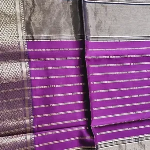 Purple handloom cotton silk Maheshwari saree with silver striped pallu and intricate zari border, displayed flat; elegant traditional Maheshwari saree design.