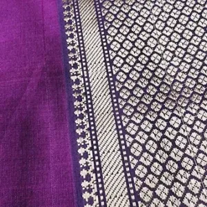 Purple handloom cotton silk Maheshwari saree with intricate silver and navy zari border pattern, shown in close-up; elegant traditional Maheshwari saree.