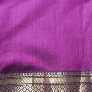 Purple handloom cotton silk Maheshwari saree with rich gold zari border, shown in close-up; elegant traditional Maheshwari saree design.