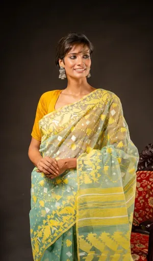 Mint green and yellow handloom Dhakai Jamdani saree with traditional geometric and floral motifs, worn by woman