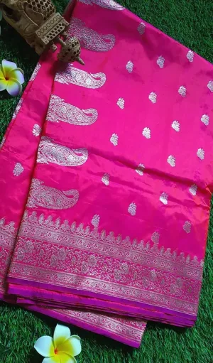 Handloom Katan Silk Sona Roopa Banarasi saree in vibrant pink with delicate gold zari motifs and intricate paisley patterns. The saree is adorned with a beautiful golden border, offering a traditional and elegant look.