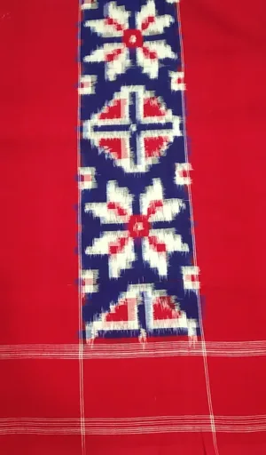 Handloom double ikat Teliya rumal saree with a red base and intricate white and blue floral patterns along the center.