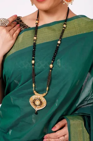 Teal green handloom pure cotton Paithani saree with subtle woven motifs and contrast zari border, worn by woman