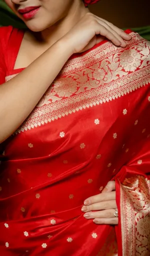 Close-up of red handloom pure silk Banarasi saree with intricate gold zari floral border and butti motifs