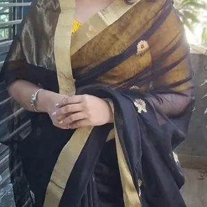 Woman wearing black and gold handloom pure silk Chanderi saree with zari border and butti motifs