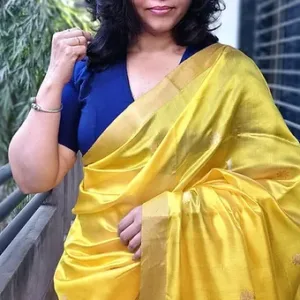 Woman wearing a yellow handloom pure silk Chanderi saree draped elegantly, showcasing intricate designs and a vibrant color.