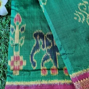 Handloom pure silk Odisha Ikat saree with intricate patterns in green, featuring traditional motifs and a decorative border.