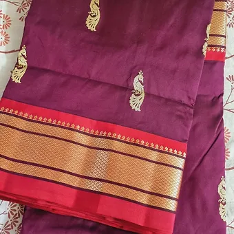 Handloom-Pure-Silk-Paithani-1 Handloom pure silk Paithani saree in deep purple with intricate peacock motifs and a contrasting red and gold border.