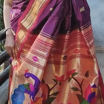 Handloom-Pure-Silk-Paithani-2 Handloom pure silk Paithani saree with intricate peacock and floral designs in vibrant colors, draped elegantly.