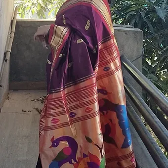 Handloom-Pure-Silk-Paithani-5 Handloom pure silk Paithani saree with intricate designs and vibrant colors, draped elegantly on a model.