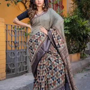 Full view of a handloom Tussar silk Mangalgiri saree highlighting Ajrakh-style multicolor triangle patterns and check weaving in earthy tones of beige, mustard, brown and black, paired with a glossy black zari textured border