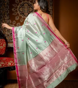 Handloom silk Chanderi saree with a light green and pink color scheme, featuring floral motifs and a shiny finish.