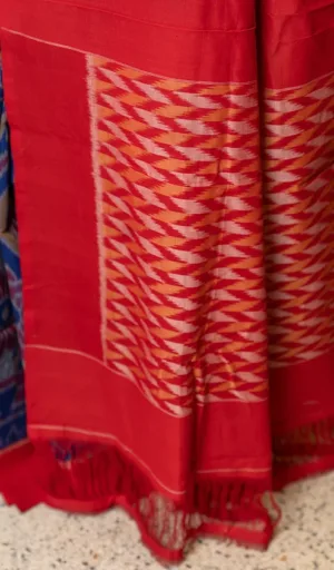Red handloom single ikat cotton saree with traditional zigzag woven pallu pattern