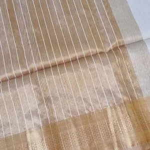 Handloom cotton silk Maheshwari saree in soft beige and ivory tones, featuring fine vertical white stripes across the body and a subtle traditional zari woven border