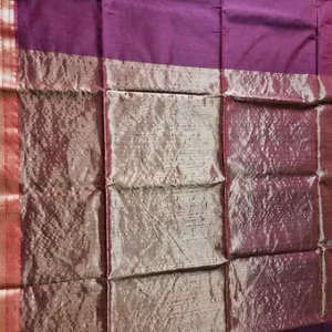 Purple handloom cotton silk Maheshwari saree with shimmering silver zari pallu and pink border, displayed flat; elegant traditional Maheshwari saree design.