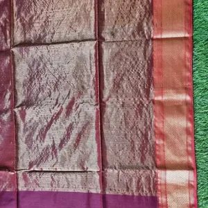 Purple handloom cotton silk Maheshwari saree with rich silver zari pallu and dual-tone pink border, displayed on grass; elegant traditional Maheshwari saree.