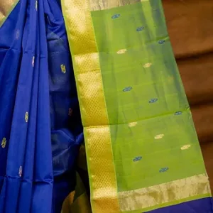 Royal blue and green handloom cotton silk Maheshwari saree with small butti motifs and gold zari border, shown in close-up; elegant traditional Maheshwari saree.