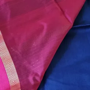 Handloom cotton silk Maheshwari fabric with a resham border in vibrant pink and blue colors.