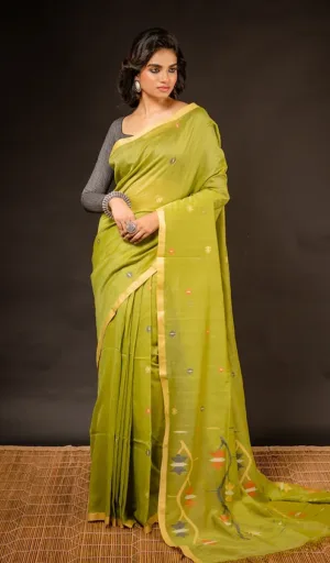 Woman wearing green handloom pure cotton Jamdani saree with delicate woven motifs and traditional drape
