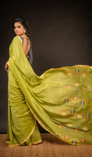 Woman wearing green handloom pure cotton Jamdani saree with flowing pallu and multicolour woven motifs
