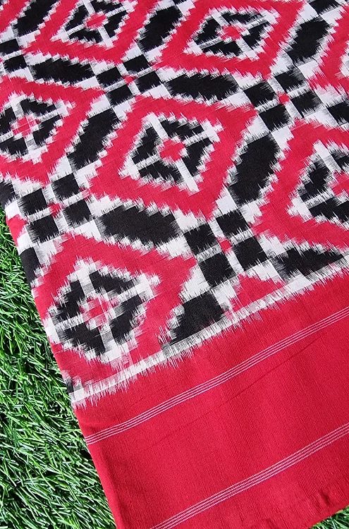 Handloom-pure-cotton-double-ikat-saree-1 Handloom double ikat saree in red, black, and white patterns with geometric designs and a solid red border.