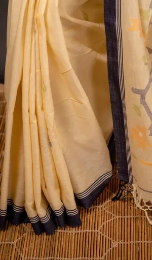 Woman wearing off-white handloom pure cotton Jamdani saree with navy blue border and woven floral motifs