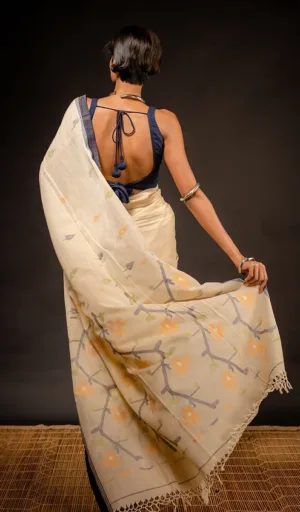 Woman wearing off-white handloom pure cotton Jamdani saree with multicolour woven floral motifs