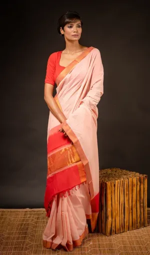Peach handloom pure cotton Mangalagiri saree with red and gold Nizam border, worn by woman in traditional style