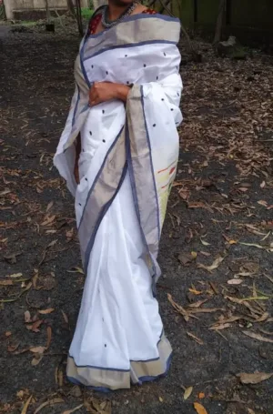 White handloom pure cotton Paithani saree with grey zari border and minimal black butti motifs, worn by woman