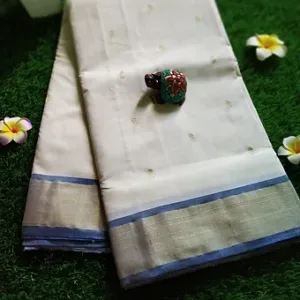 Two handloom pure cotton Paithani sarees with a decorative border and a colorful embellishment placed on top.