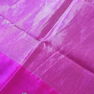 Handloom pure silk Chanderi fabric in vibrant pink with a textured surface and subtle sheen.