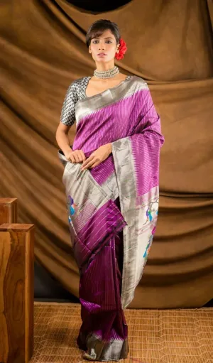Purple and silver handloom pure silk Paithani brocade saree with traditional peacock motifs, worn by woman