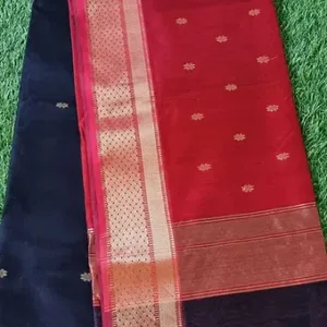 Red and navy blue handloom pure silk Chanderi saree with silver floral butti motifs and elegant zari border, displayed flat on grass; traditional festive silk saree.