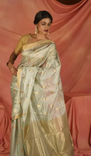 Chanderi saree made from pure silk, featuring intricate designs and a blend of soft colors, worn by a model with traditional jewelry.