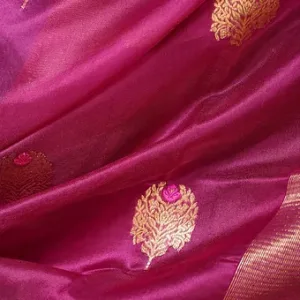 Magenta pure silk Chanderi handloom saree with golden floral butti motifs and shimmering zari border, shown in close-up; elegant festive silk saree fabric
