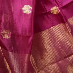 Magenta pure silk Chanderi handloom saree with golden zari border and floral butti motifs, displayed flat; elegant festive and traditional silk saree.