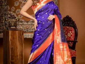 Royal blue handloom pure silk Paithani saree with orange zari border and traditional woven motifs, worn by woman
