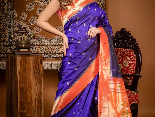 Handloom-pure-silk-paithani-1 Royal blue handloom pure silk Paithani saree with orange zari border and traditional woven motifs, worn by woman