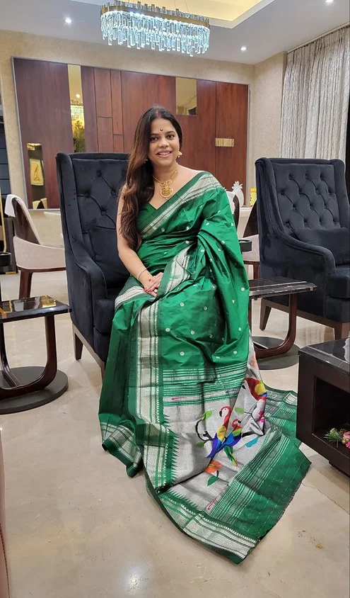 Handloom-pure-silk-paithani-2 Green handloom pure silk Paithani saree with silver zari border and traditional peacock motif pallu, worn by woman