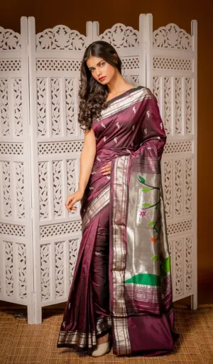 Wine purple handloom pure silk Paithani saree with silver zari border and traditional woven motifs, worn by woman