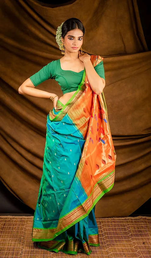Handloom-pure-silk-paithani-2 Teal green and orange handloom pure silk Paithani saree with traditional zari border and woven motifs, worn by woman