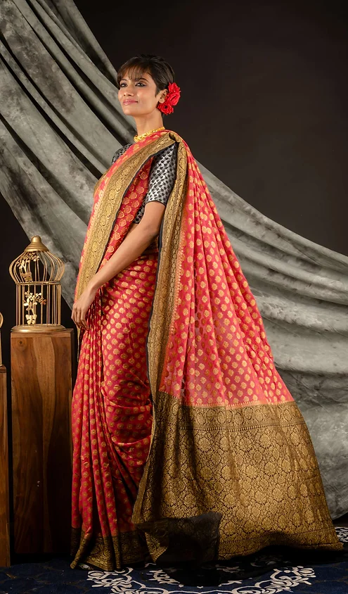 Handwoven-Pure-Georgette-Banarasi-Saree-2 Handwoven pure georgette Banarasi saree in red with gold patterns, worn by a model with a flower in her hair.