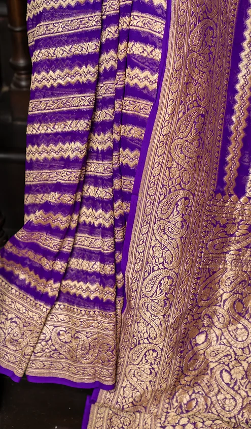 Handwoven-Pure-Khaddi-Georgette-Banarasi-4 Handwoven pure Khaddi Georgette Banarasi saree in deep purple with intricate gold embroidery and traditional patterns.