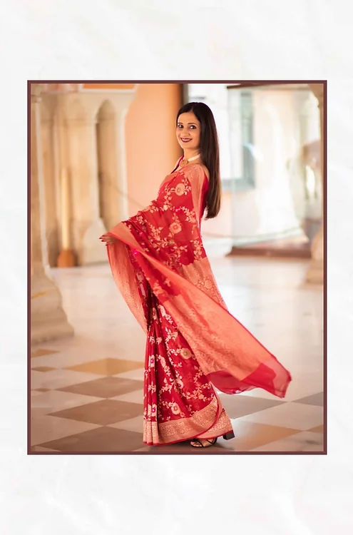 Handwoven-pure-chiffon-Tilfi-Banarasi-Saree-1 Red handwoven pure chiffon Tilfi Banarasi saree with silver zari floral motifs and flowing pallu, worn by model